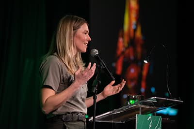 2019 Auction keynote speaker Annie Kilby gives her address behind a podium