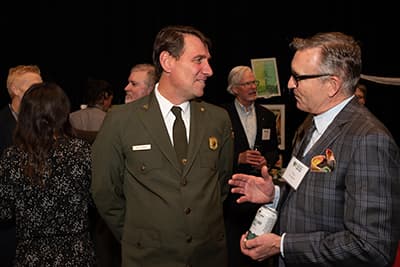 Park staff speaks with an attendee