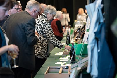 Auction participants browse the item listings ahead of the live auction