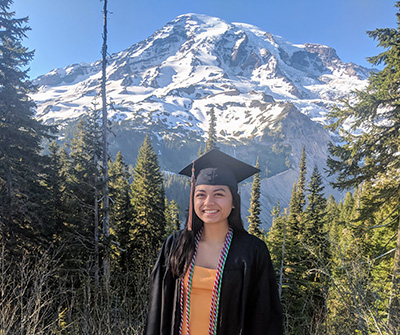 A graduation photo posed in front of Mount Rainier