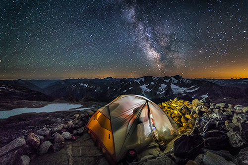 The Milky Way appears over a tent on Sahale Pass in the North Cascades