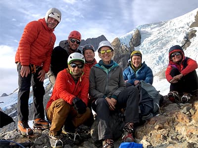 The WNPF 2021 Olympus climb team poses for a group shot on the glacier