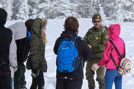 A ranger speaks with middle school students at Olympic