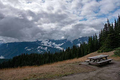 A picnic table with a view of the Olympic range