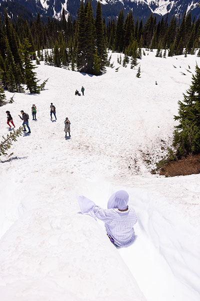 Mary's Place participants slide down the snow at Mount Rainier