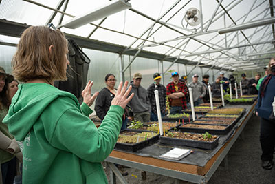 NPS staff show students plants in the greenhouse