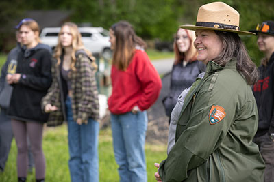 Park ranger smiles in front of student group