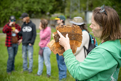 NPS staff show students a tree cross section