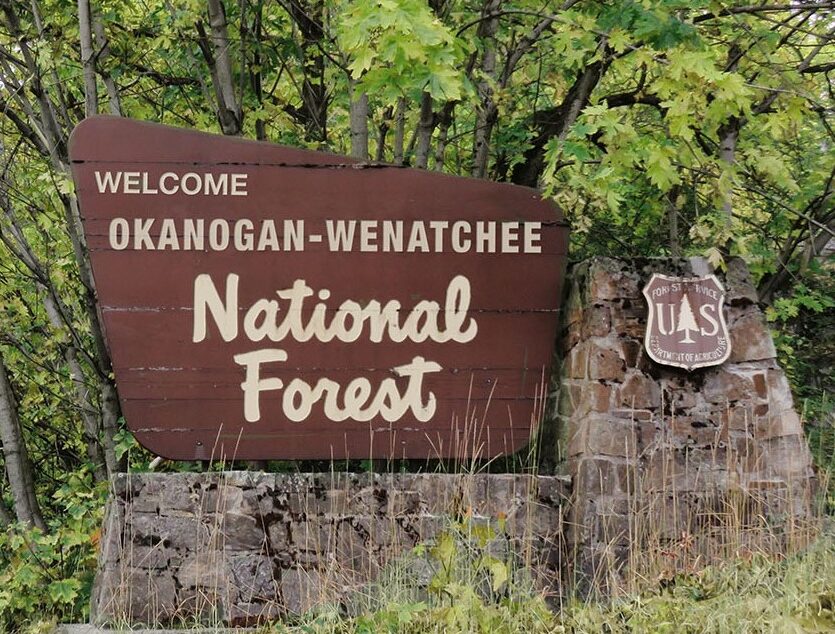 Photo of an entrance sign reading "Welcome Okanogan-Wenatchee National Forest"