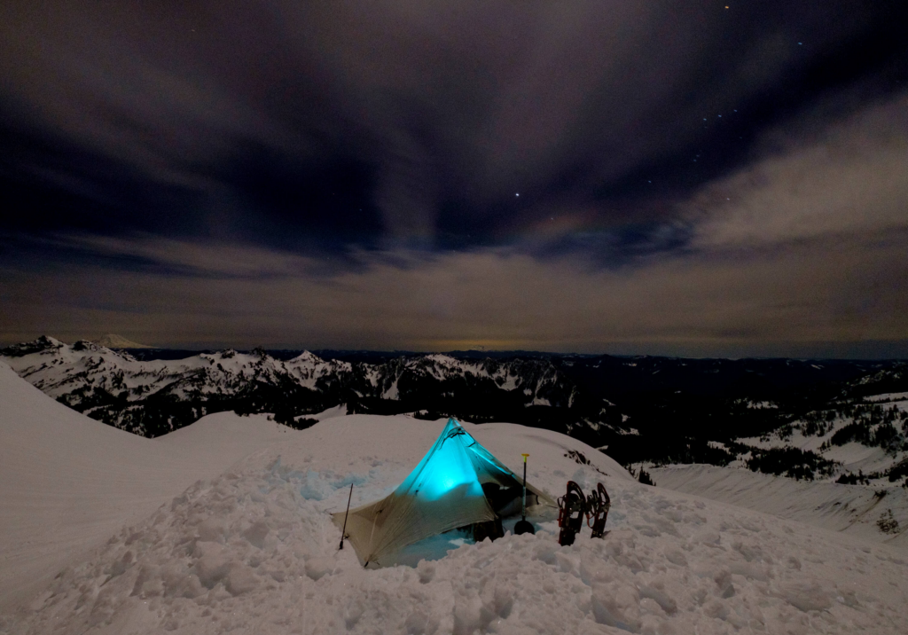 Photo of a tent and snowshoes at Panorama Point in the dark.