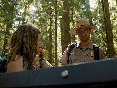 An Adventures in Your Big Backyard participant asks a ranger a question about a plant on the trail