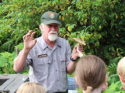 Ranger teaches young park visitors about decomposers in the park