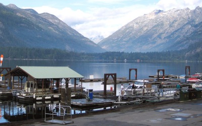 View of a boat dock at  Ross Lake and mountains in the back. 