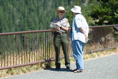 A ranger speaking with a park visitor at the Diablo Lake Overlook.