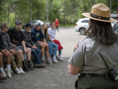 Image of a park ranger facing a crowd of high school students.