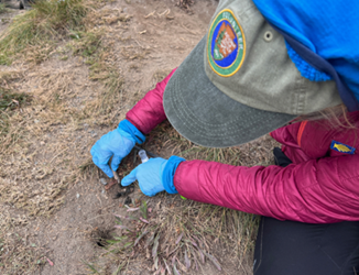 A photo of a person on the ground wearing a volunteer hat
