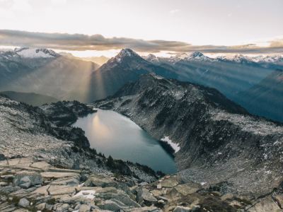 An image of a lake basin with sun beams breaking through the clouds.