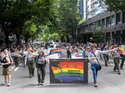 A group of rangers walking in a parade with a sign that says "relevancy diversity inclusion"