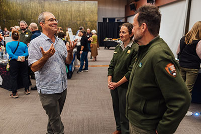 Attendees speak with park leaders