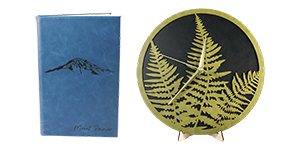 A leather journal and a fern clock by Harrelson Handcrafted